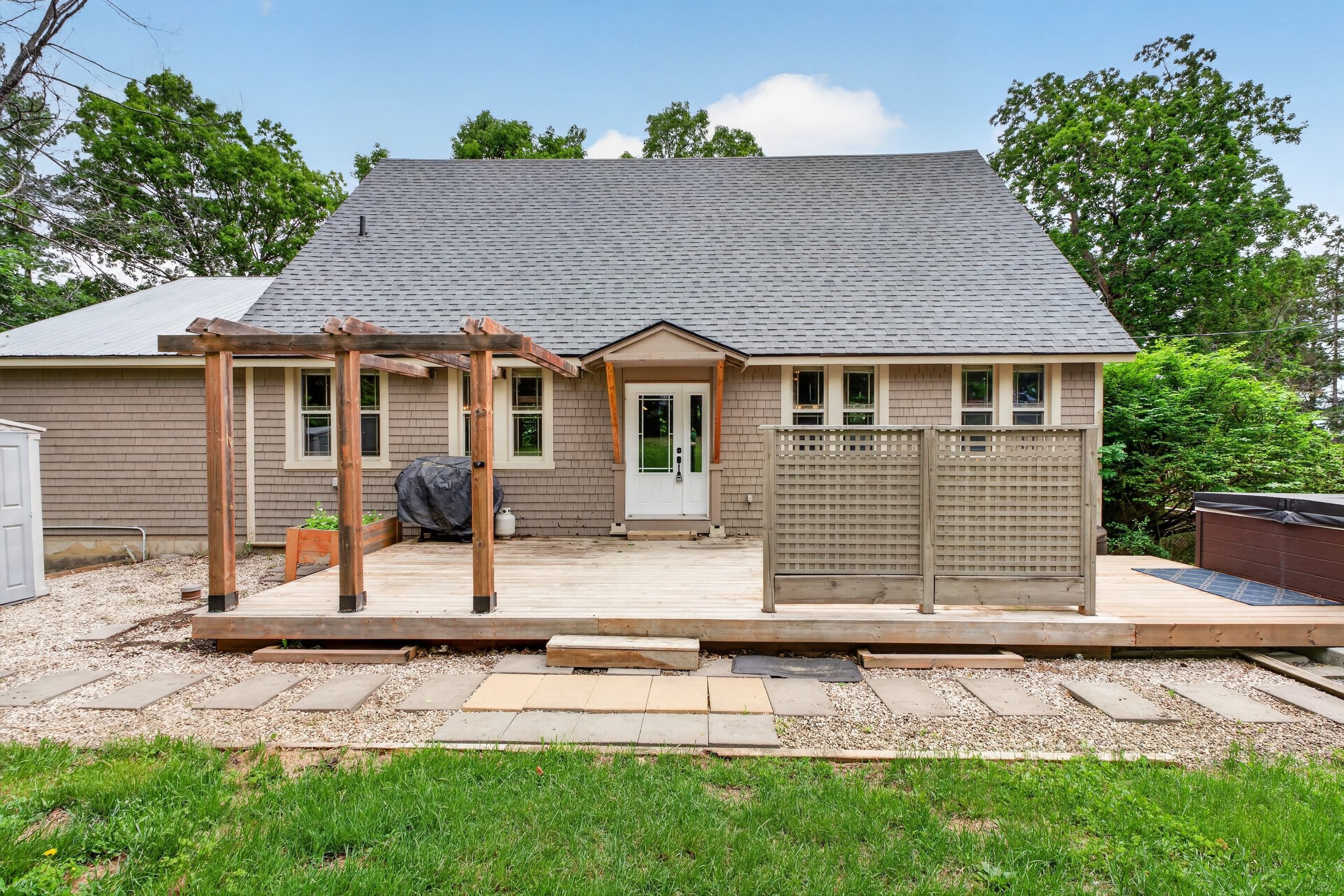 Spacious back deck with pergola and hot tub