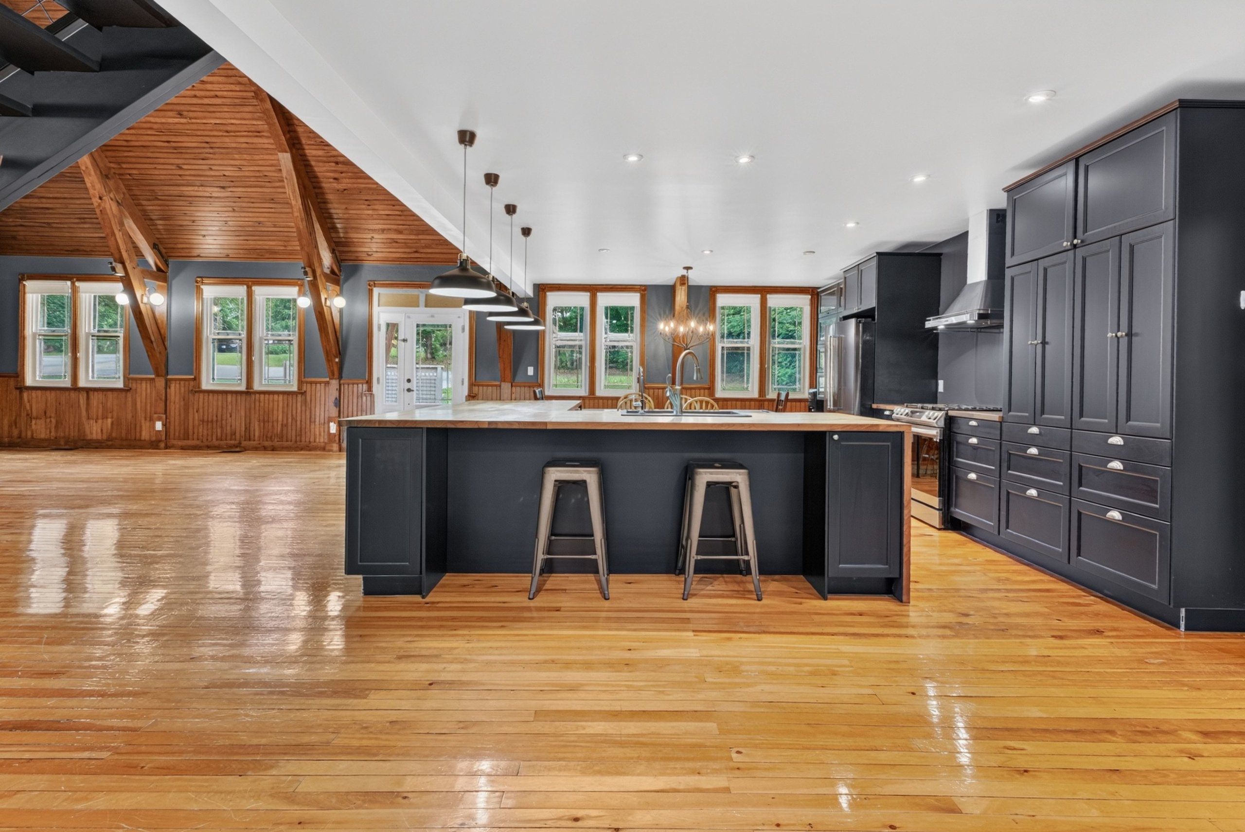 Open-concept great room and kitchen under the vaulted ceiling
